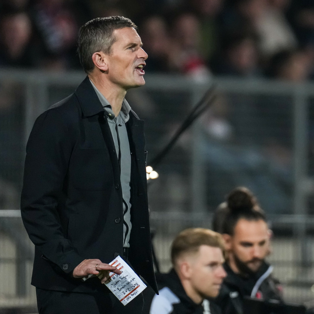Jurgen Seegers coachend langs het veld, met notities in zijn hand.